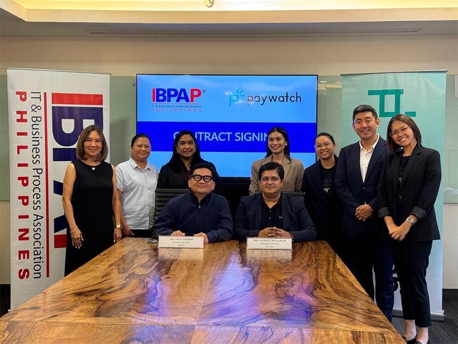 (Seated from left) IBPAP president and CEO Jack Madrid and Sandeep Mulajkar, managing director of Paywatch Philippines. Standing are Alex Kim, president and co-founder of Paywatch (second right), and Celeste Ilagan, COO of IBPAP (left).