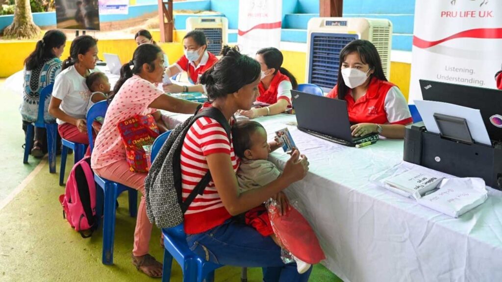 Mothers receiving the FREE PRUMedCare — Select Infectious Disease coverage vouchers for their babies for the PRUBabiescampaign.