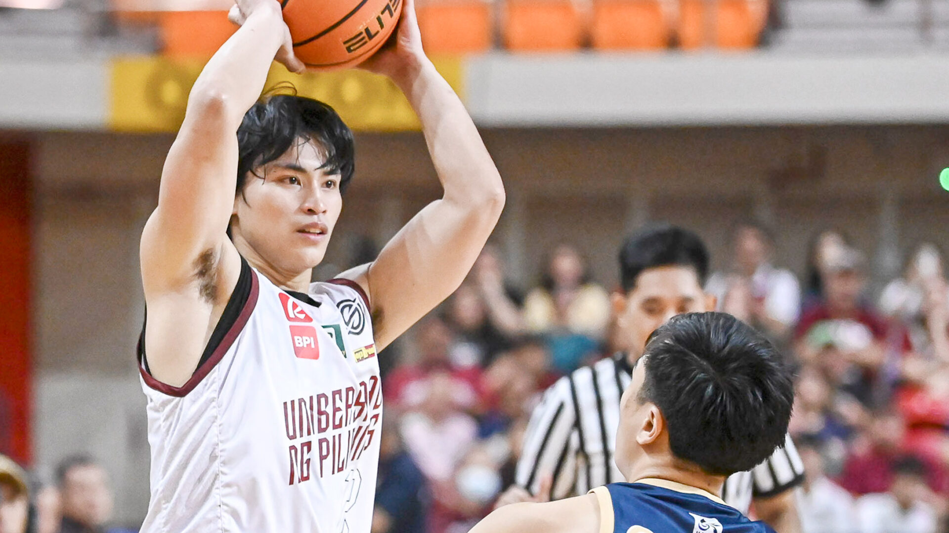 IN VAIN: University of the Philippines guard JD Cagulangan looks to pass off National University’s Tebol Garcia in last Sunday night’s game where the Bulldogs prevailed 67-47. UAAP Photo