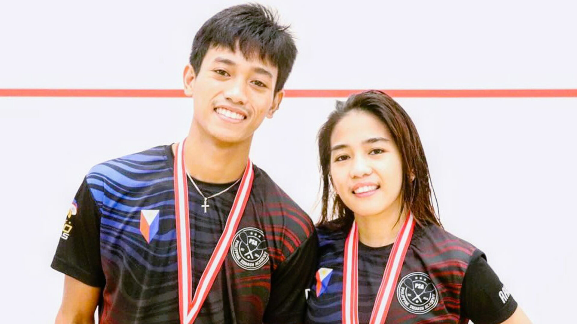 TRIUMPHANT: Meljohn and Jeymca Aribado display the gold medals they won in Singapore.