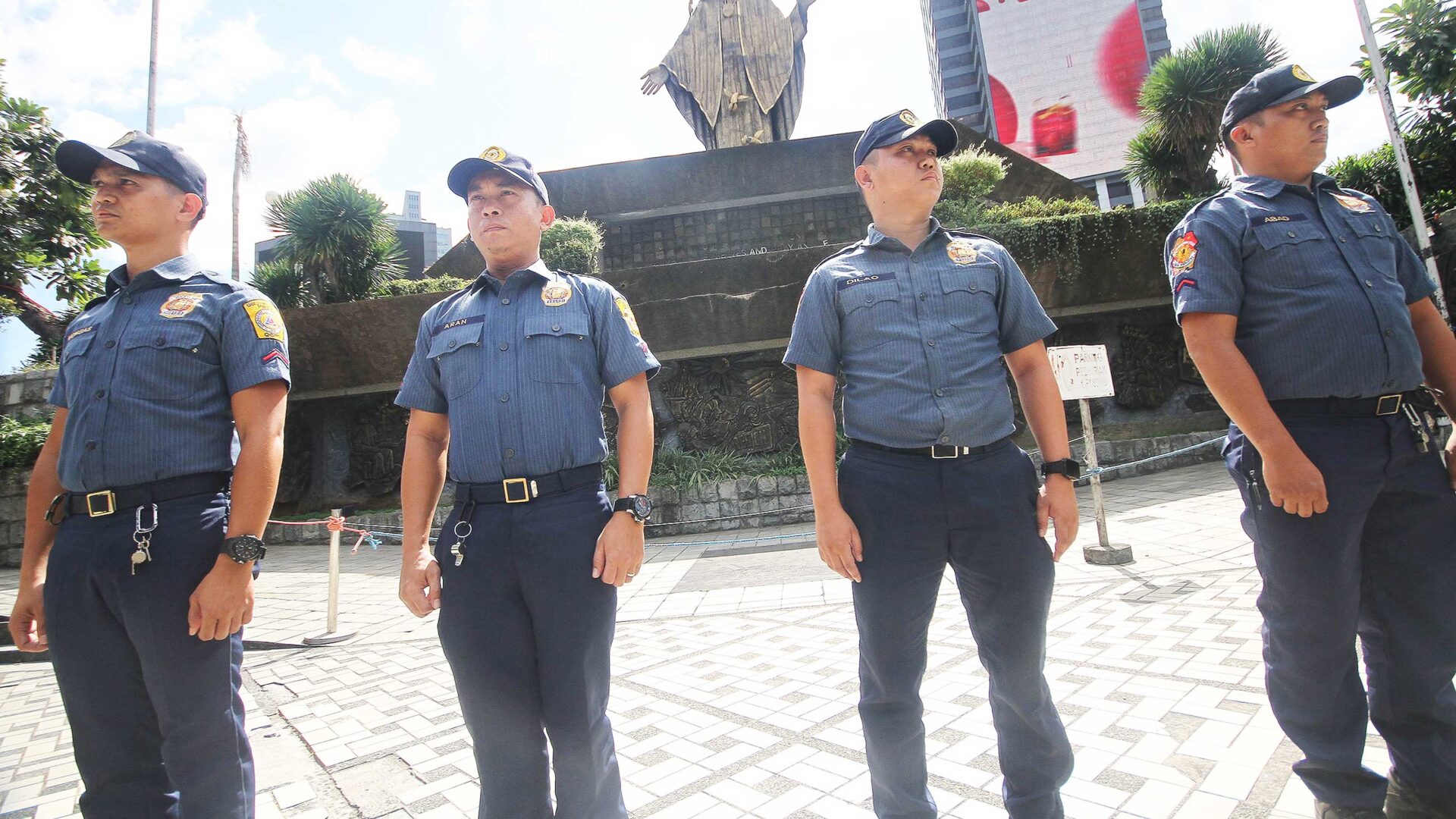 Tight watch. Personnel of the Quezon City Police Department make their presence felt at the EDSA Shrine on Wednesday to deter backers of Vice President Sara Duterte from holding a mass action in the area. Hundreds of Duterte’s supporters camped at the Shrine on Tuesday night as the House quad panel probed her office’s use of confidential funds. PHOTO BY ROLLY SALVADOR
