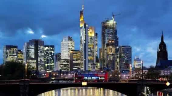 A double decker bus passes the skyline with its dominating banking district in Frankfurt, Germany. (Reuters Photo)