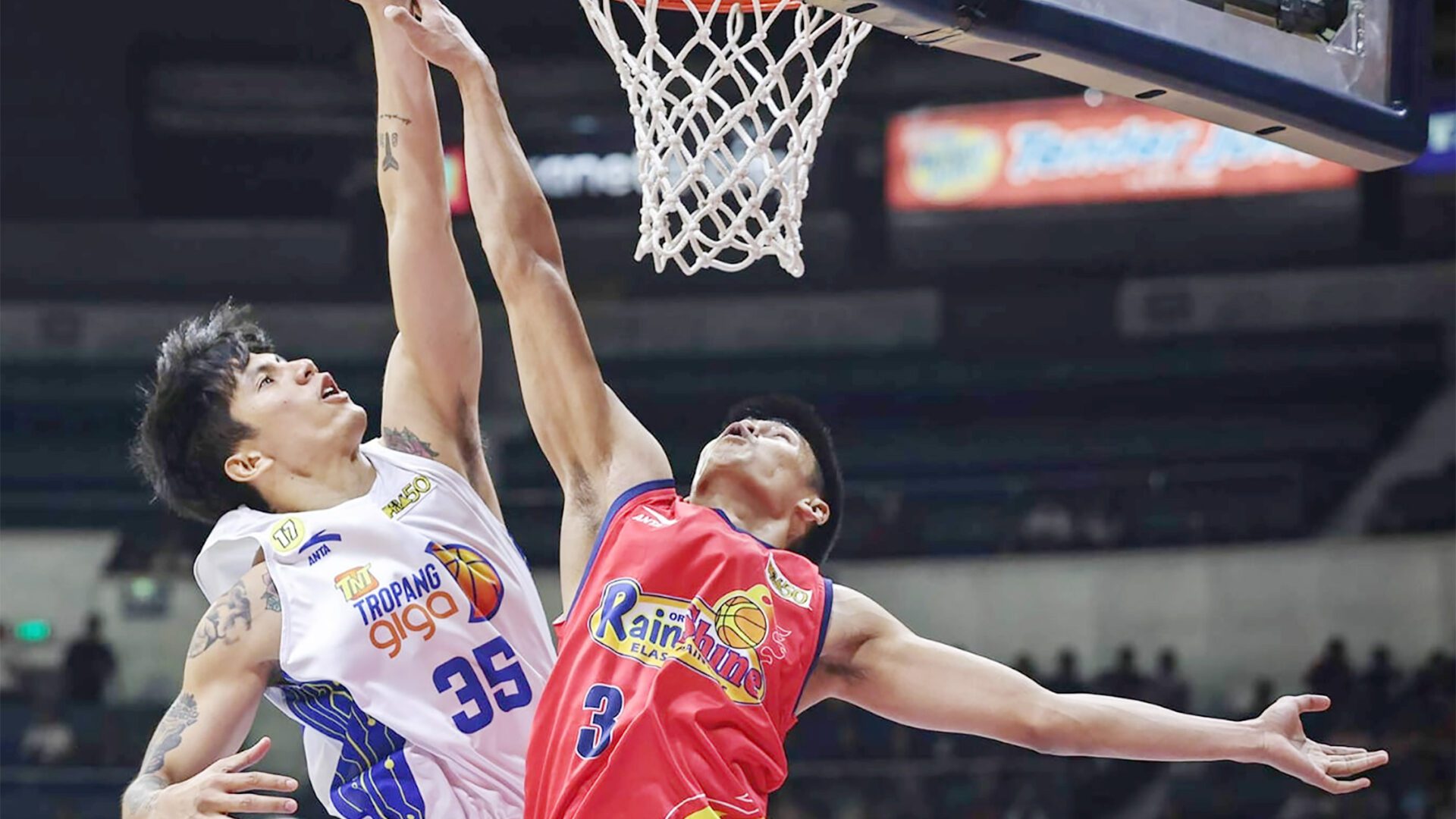 SOARING: TNT guard Kim Aurin scores off Rain or Shine counterpart Gian Mamuyac in last Wednesday night’s Game 4 won by the Tropang Giga 93-85.