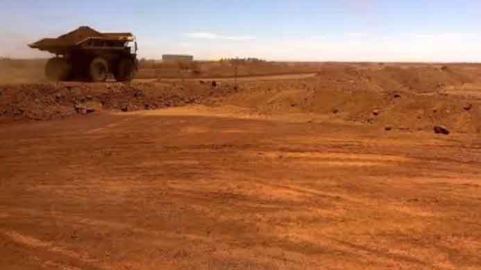 An autonomous vehicle drives along a road as it collects iron ore at Australia's Fortescue Metals Group (FMG) mine in the Pilbara region, Western Australia. (Reuters Photo)