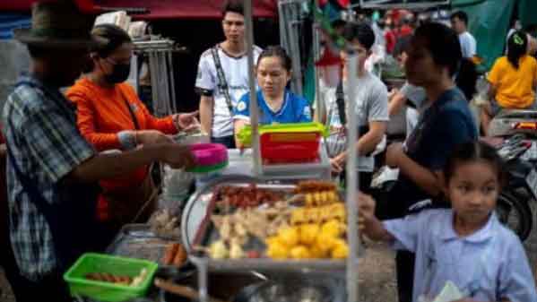 People buy street food at a market, in Bangkok, Thailand. (Reuters Photo)