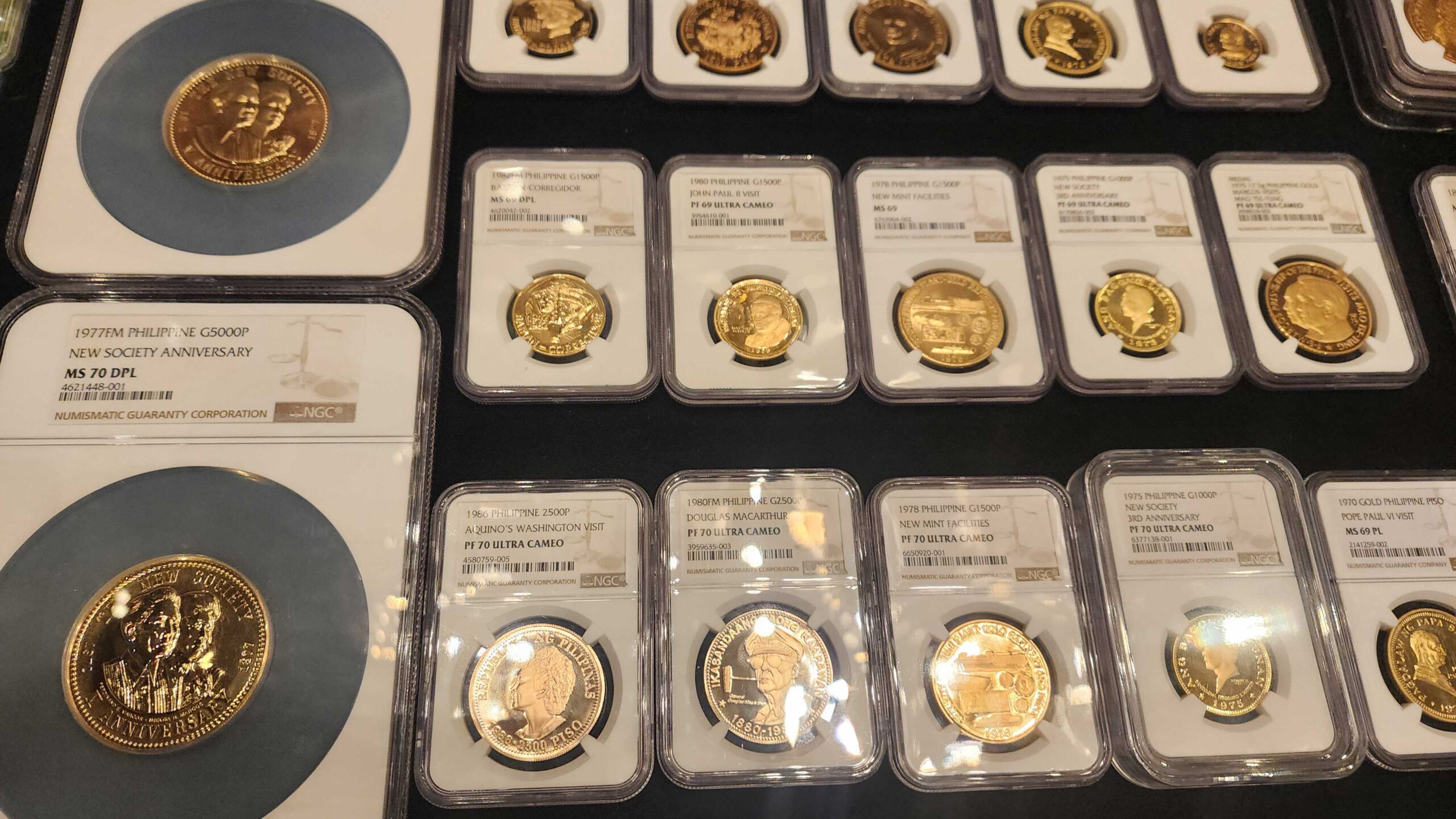 A collection of perfectly-graded commemorative gold coins
