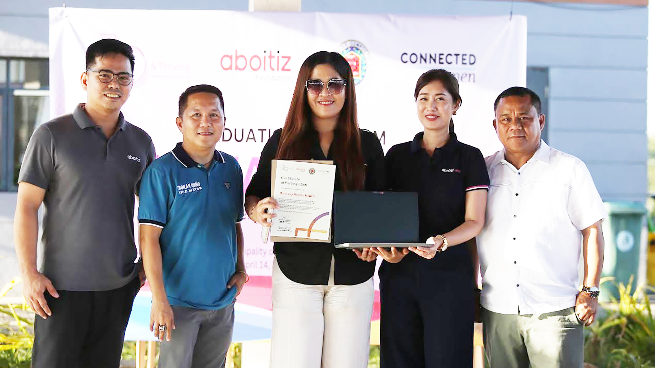 Aboitiz Land empowers women for the digital economy, vividly demonstrated here on April 14, 2025, in Compostela, Cebu. Mary Joy Medillo Mabida (center), top performer of the innovative Elevate AIDA skills training program, receives her certificate and a laptop provided by Aboitiz Land. Photo from left” Mr. Gero Torres, Impact Lead Aboitiz Foundation, Hon. Froilan Quino Municipal Vice Mayor, Ms. Farrah Nina Mayol Senior Assistant Vice President Aboitiz Land, Hon Felijur Quino Municipal Mayor